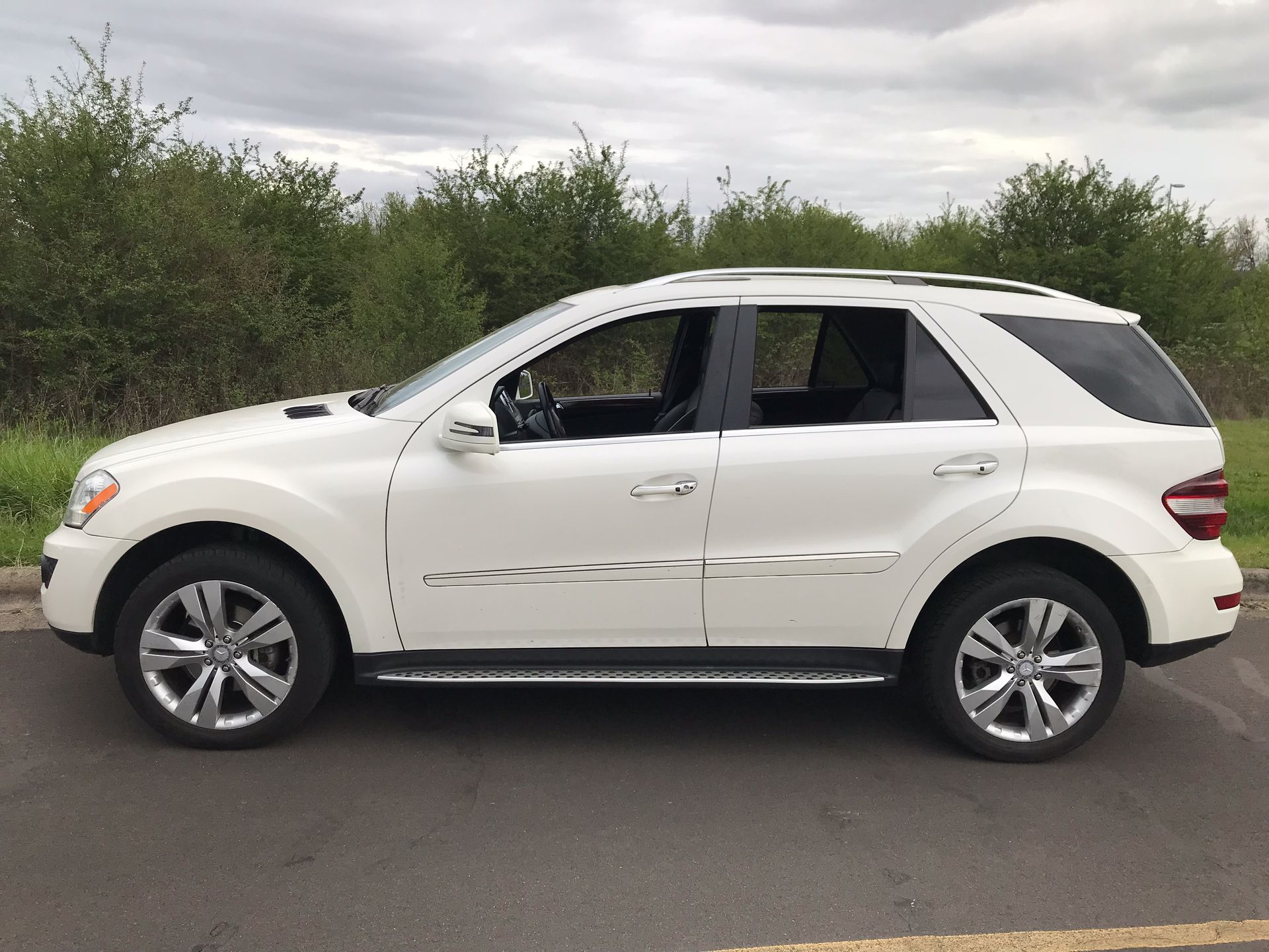 A white suv is parked on the side of the road
