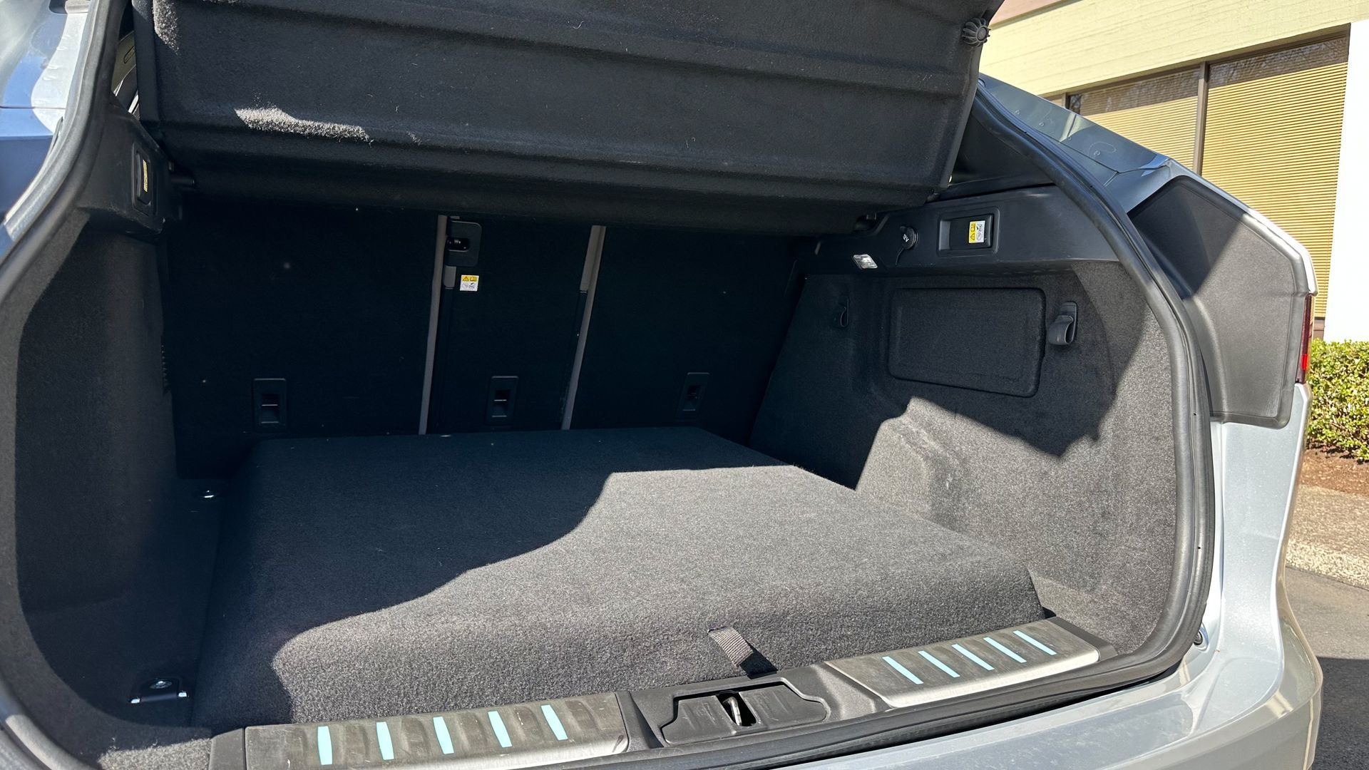 The trunk of a car with the trunk lid open.