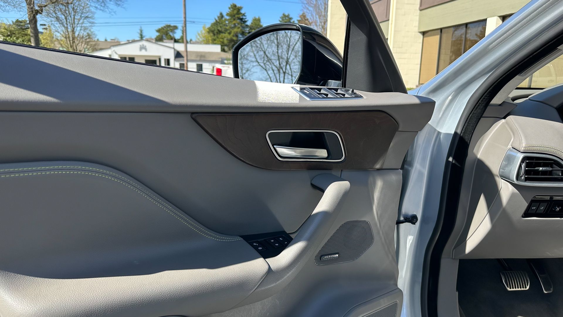 A close up of a car door with the door open.