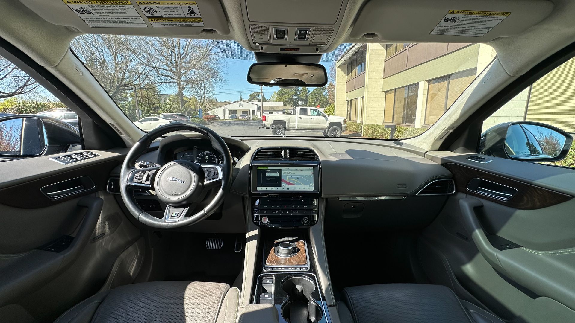 The inside of a car with a steering wheel and dashboard.