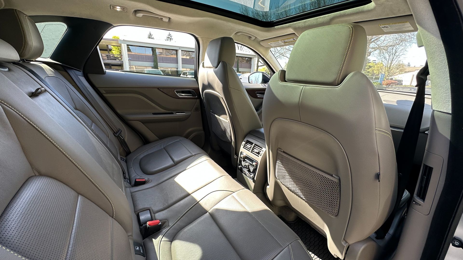 The back seat of a car with a sunroof.