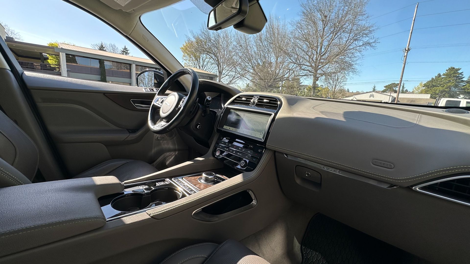 The interior of a car with a steering wheel and dashboard.