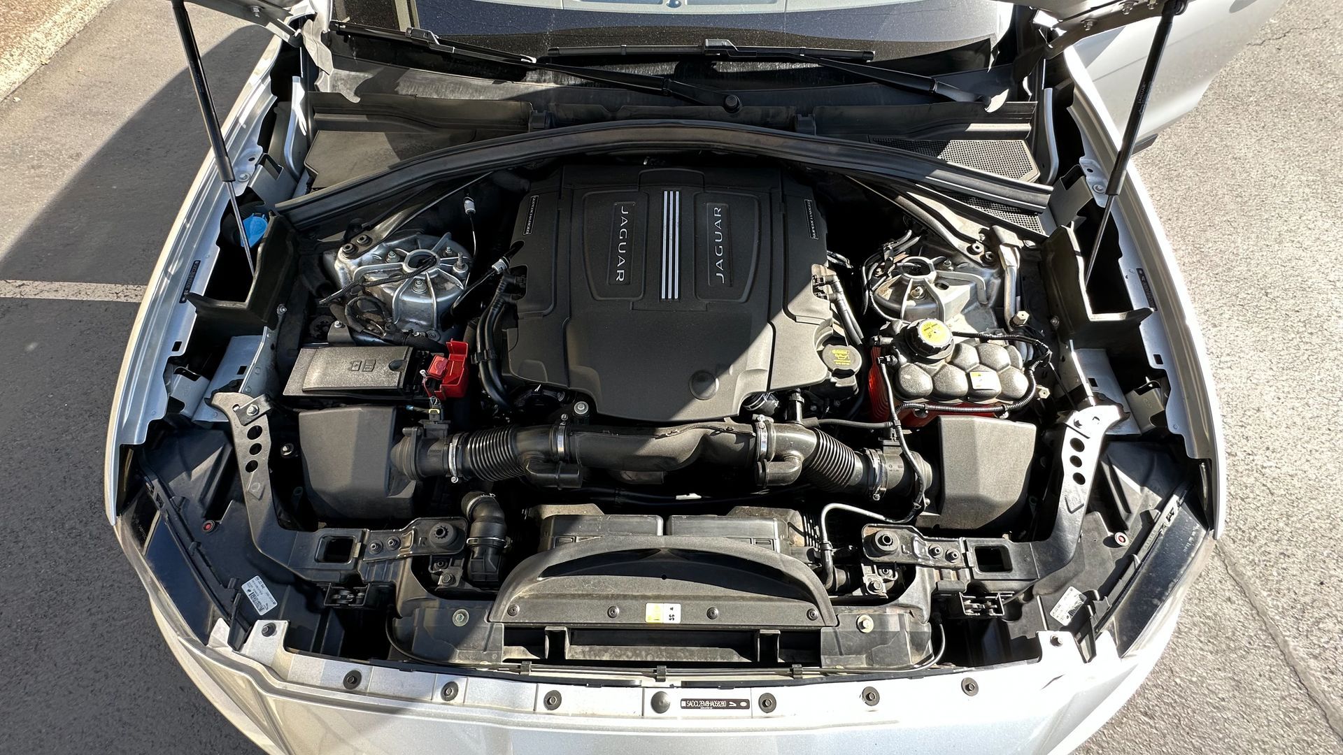 The engine of a car is shown with the hood open.
