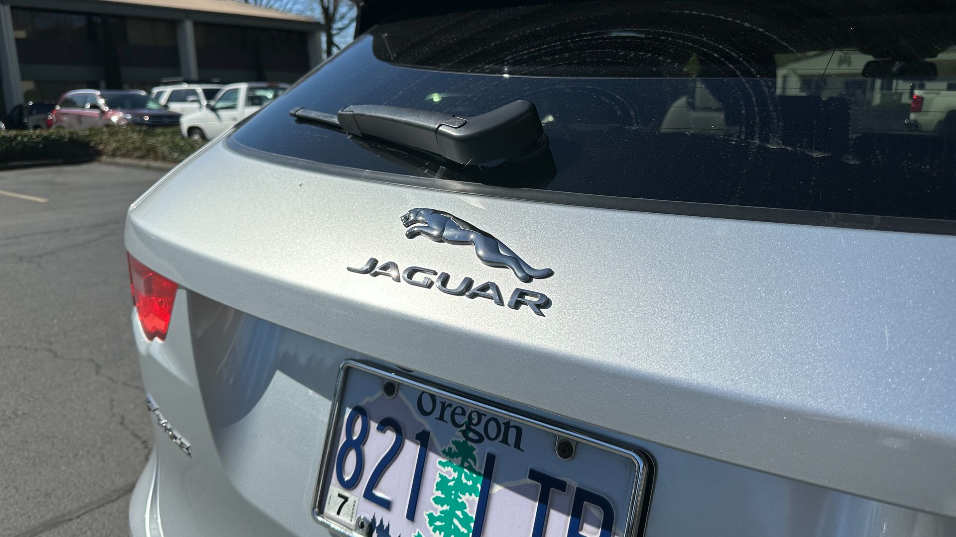 The back of a silver jaguar with a oregon license plate