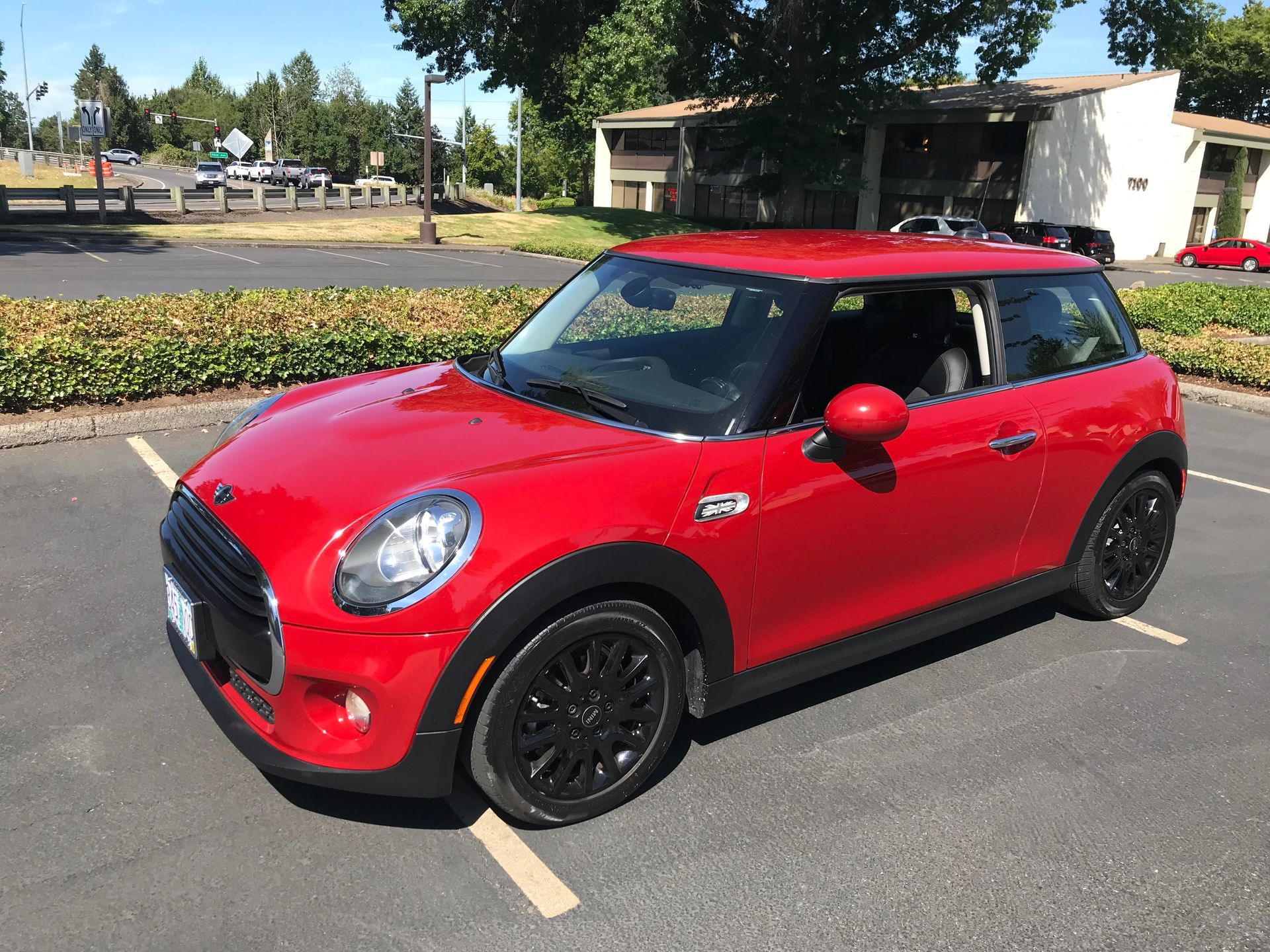 A red mini cooper is parked in a parking lot