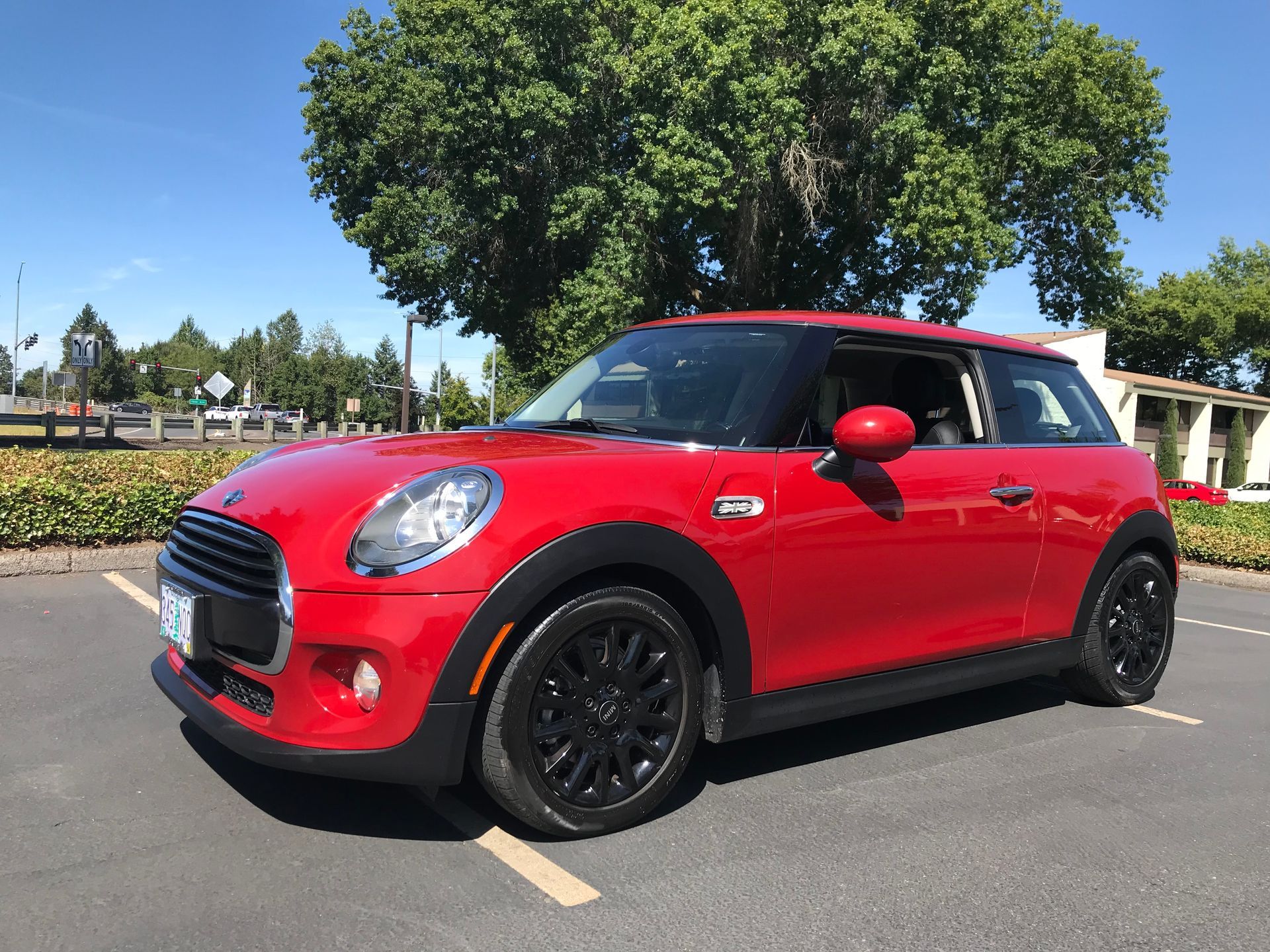 A red mini cooper is parked in a parking lot.