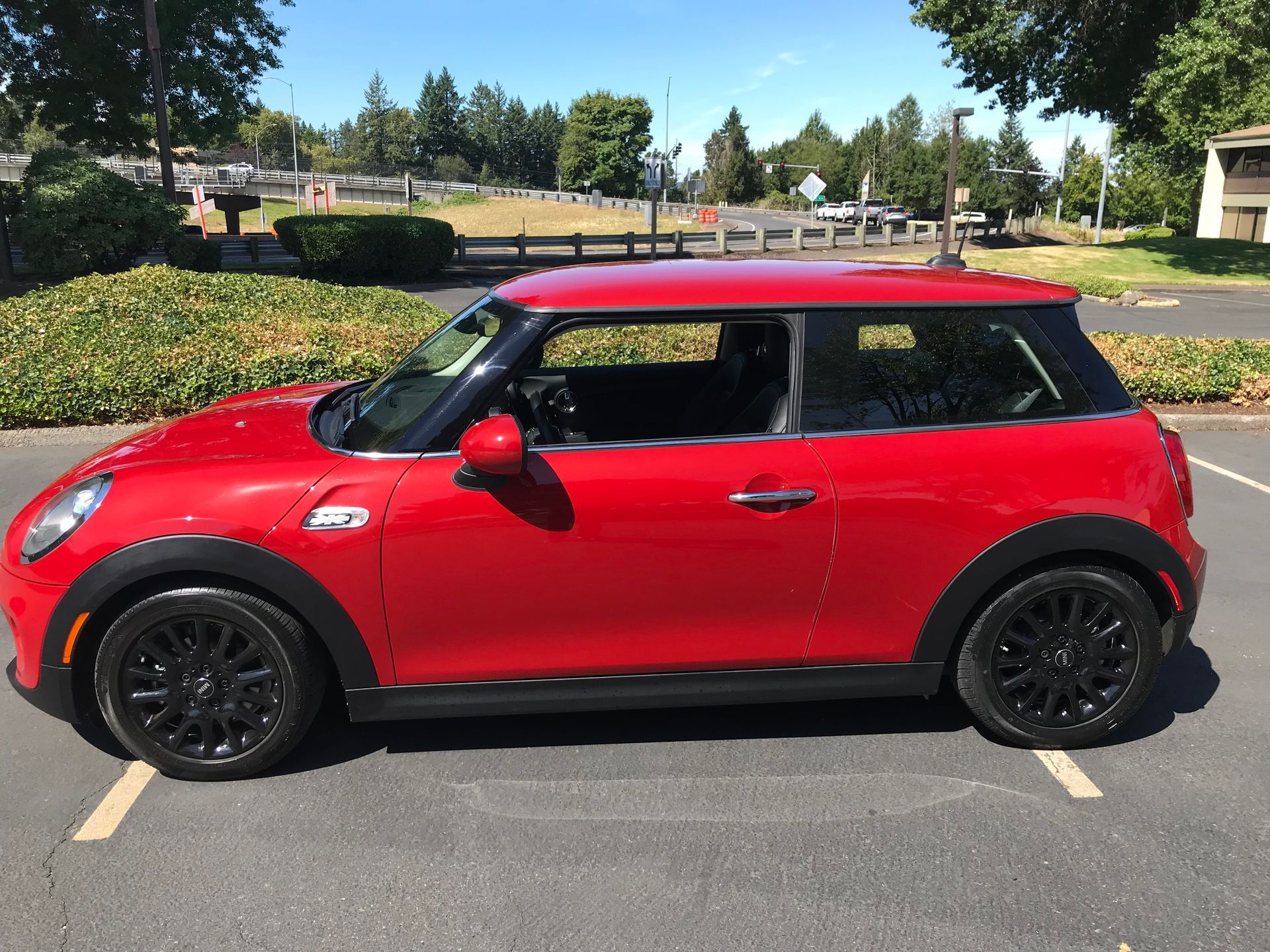 A red mini cooper is parked in a parking lot