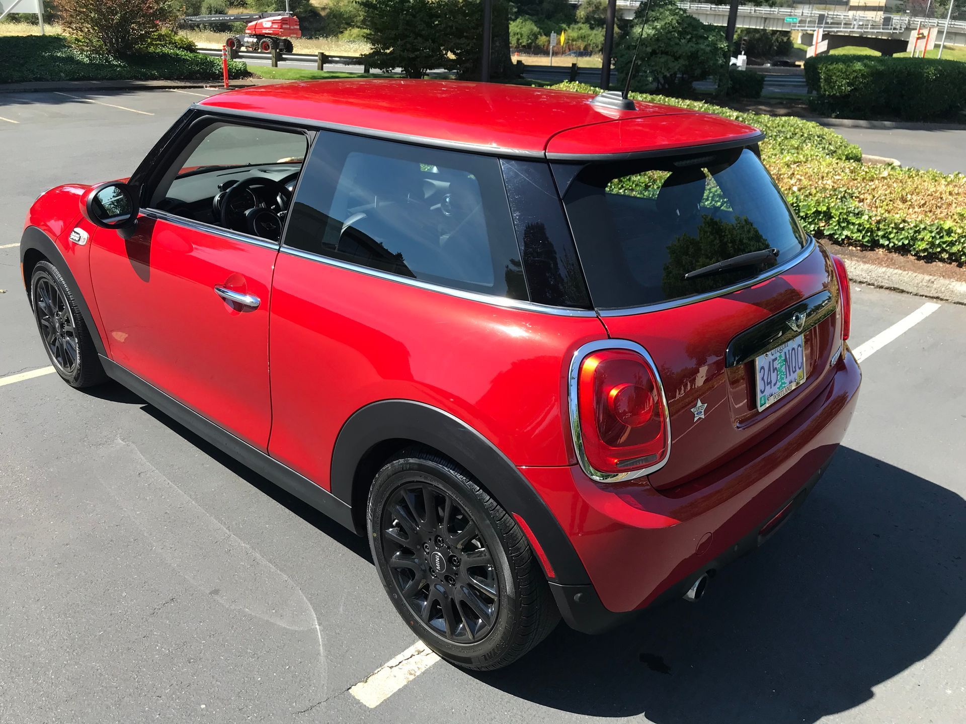 A red mini cooper is parked in a parking lot