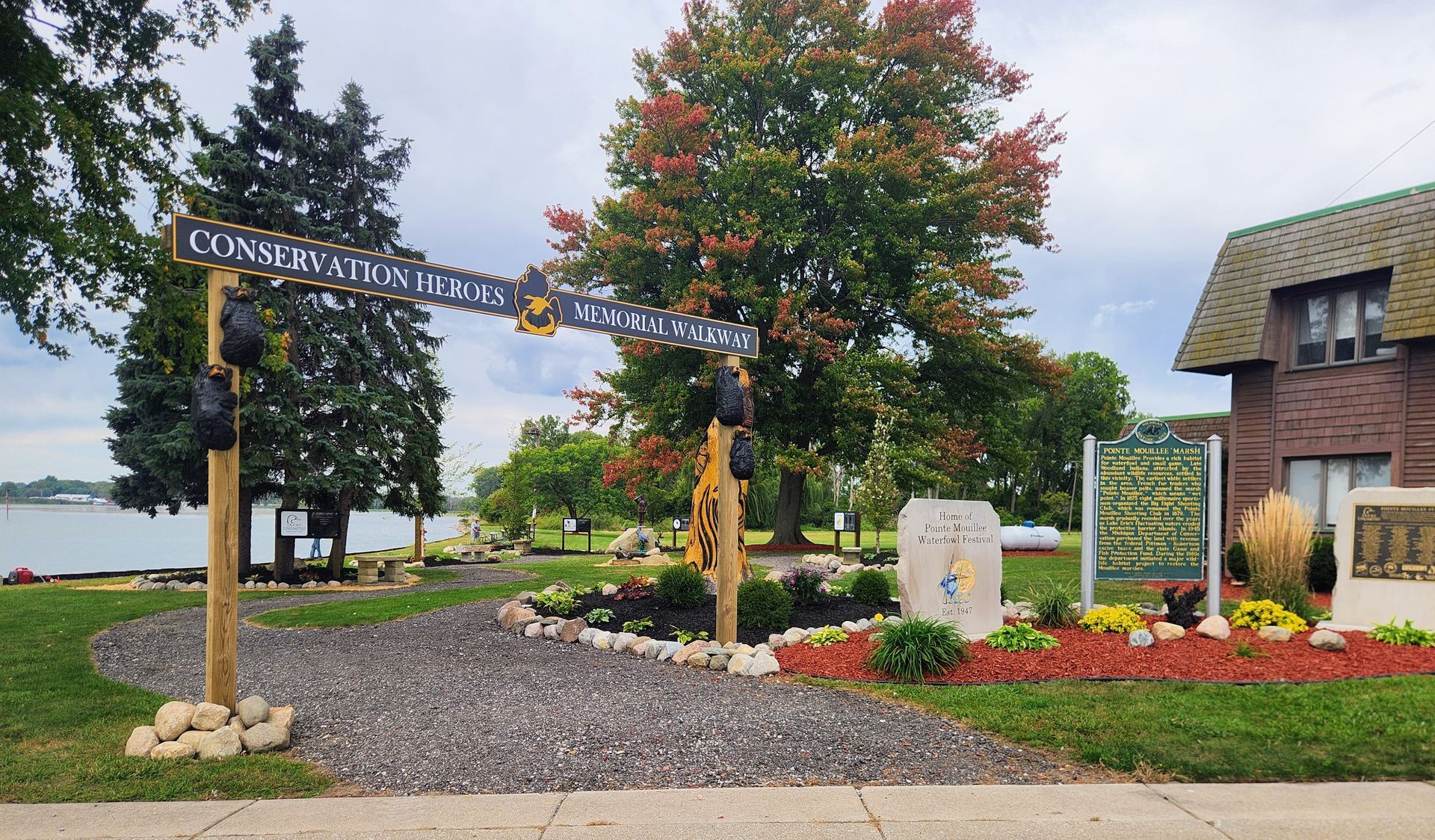 A park entrance with a wooden sign reading 