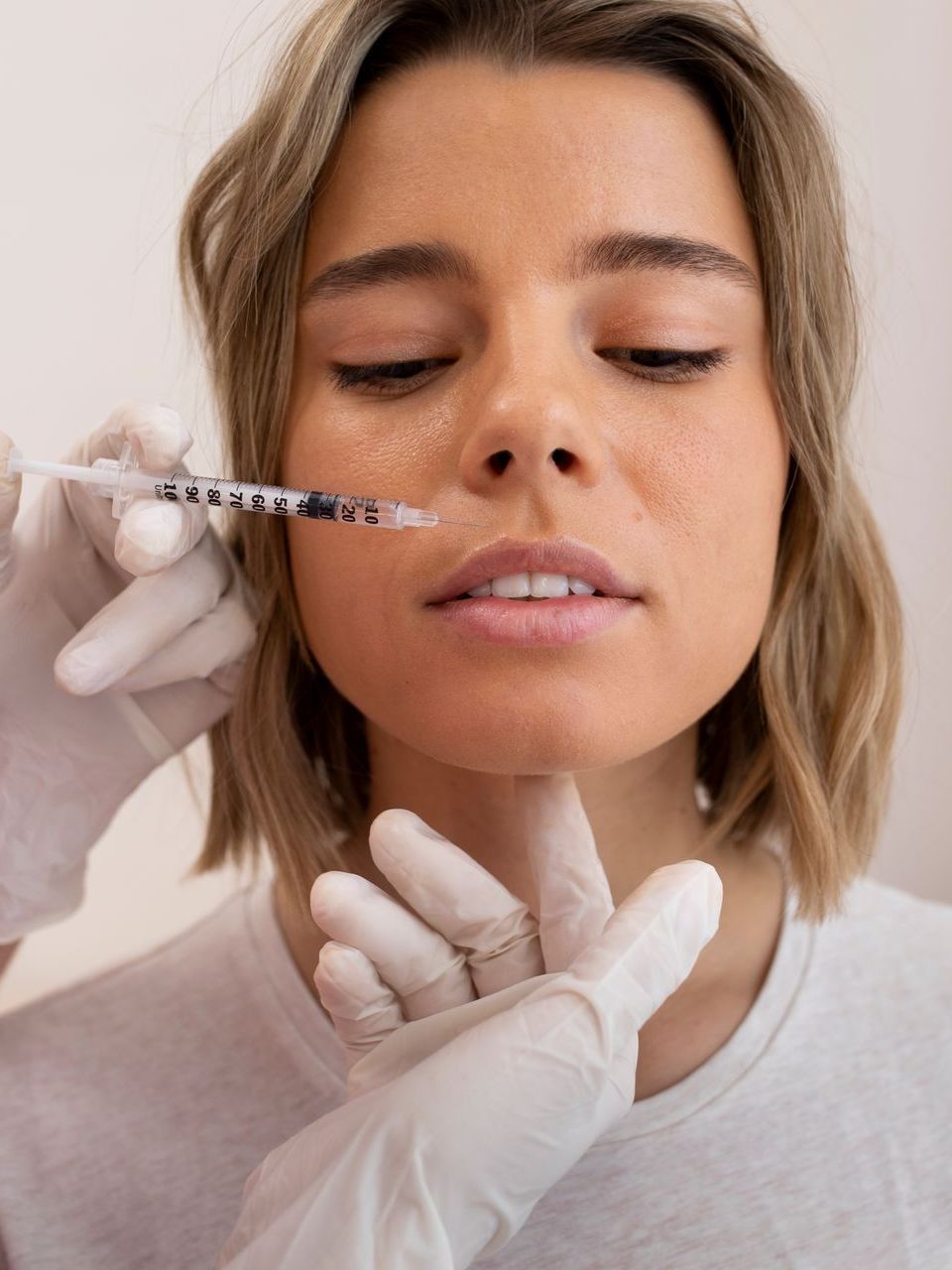 woman holding cosmetic injection needle