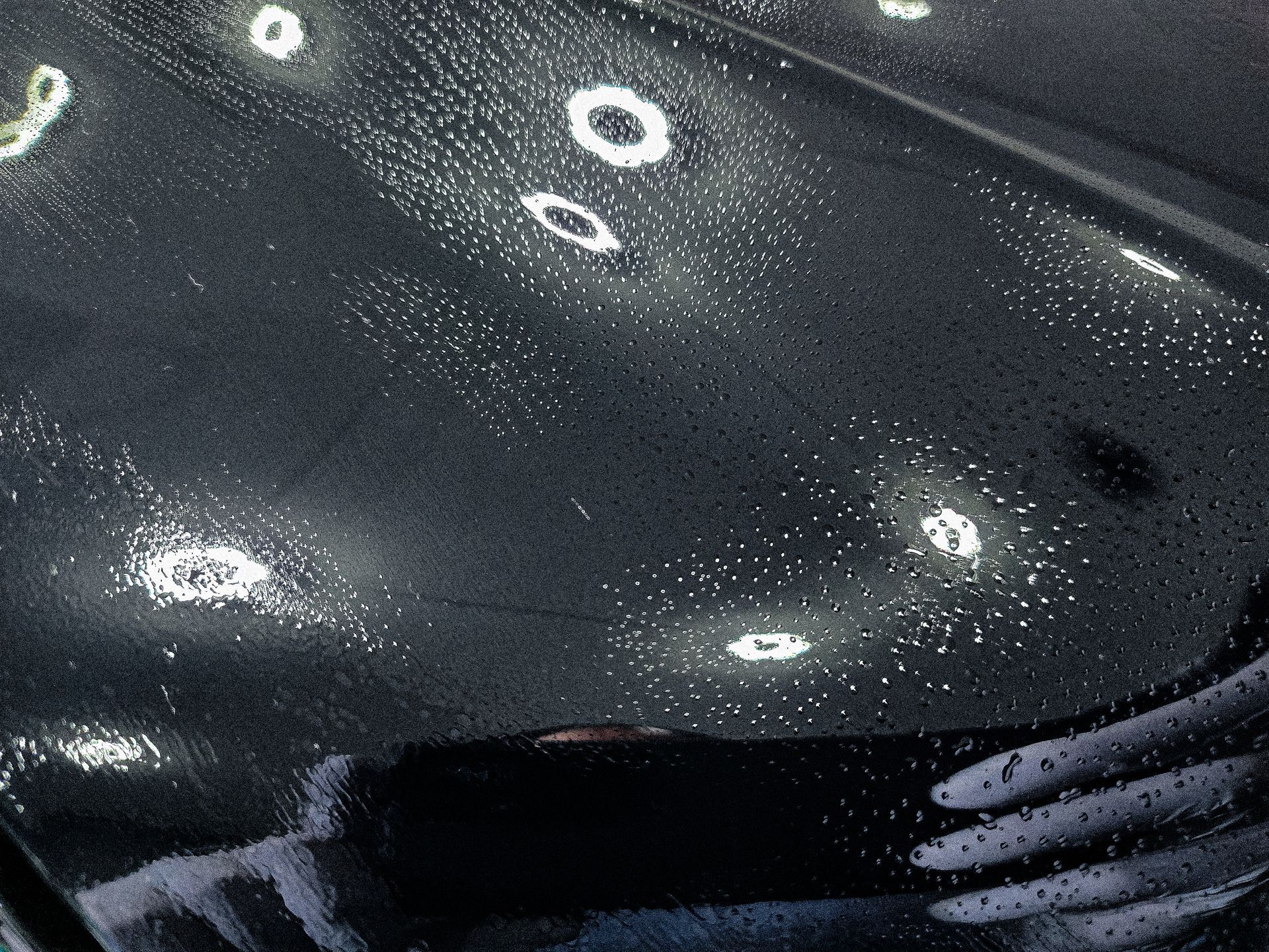 Chattanooga ceramic coating flashing on the hood of a black car