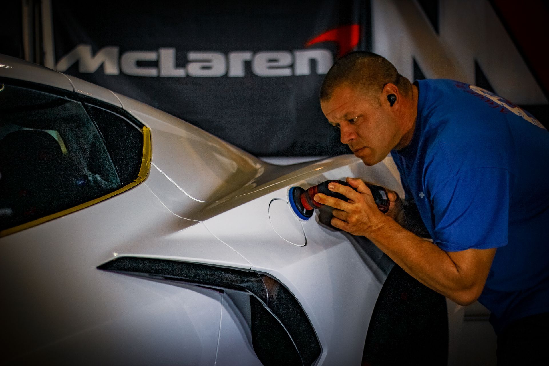 A close up of a car door with a reflection of a car in it