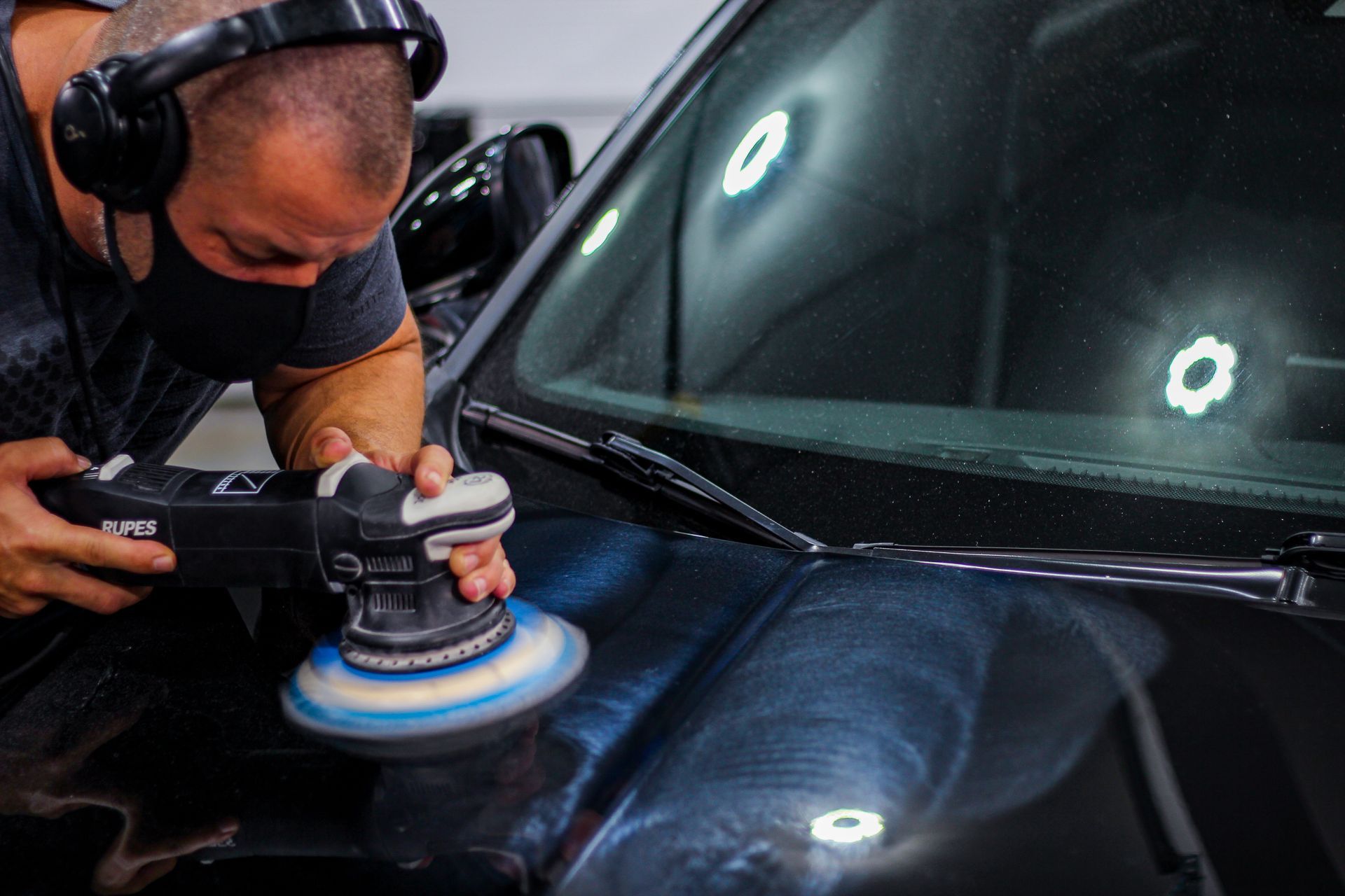 Paint correction on a black car hood, detailing, and ceramic coatings by Ringgold Auto Detail. 