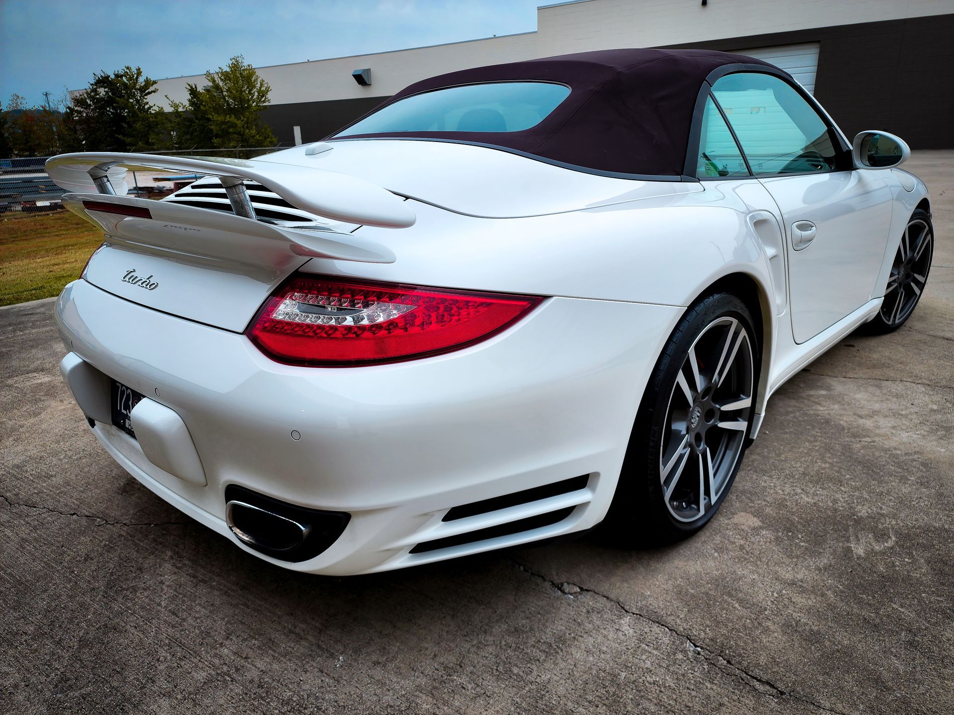 A white convertible Porsche 911 getting ready for a paint correction and possible ceramic coating.