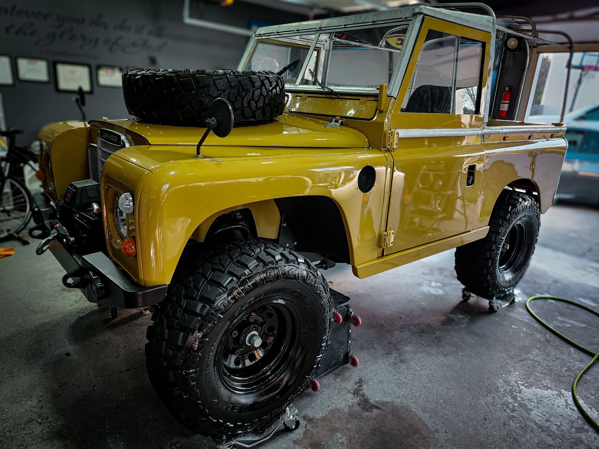 A yellow vintage Land Rover Series II that has paint correction and ceramic coating by Ringgold Auto Detail.