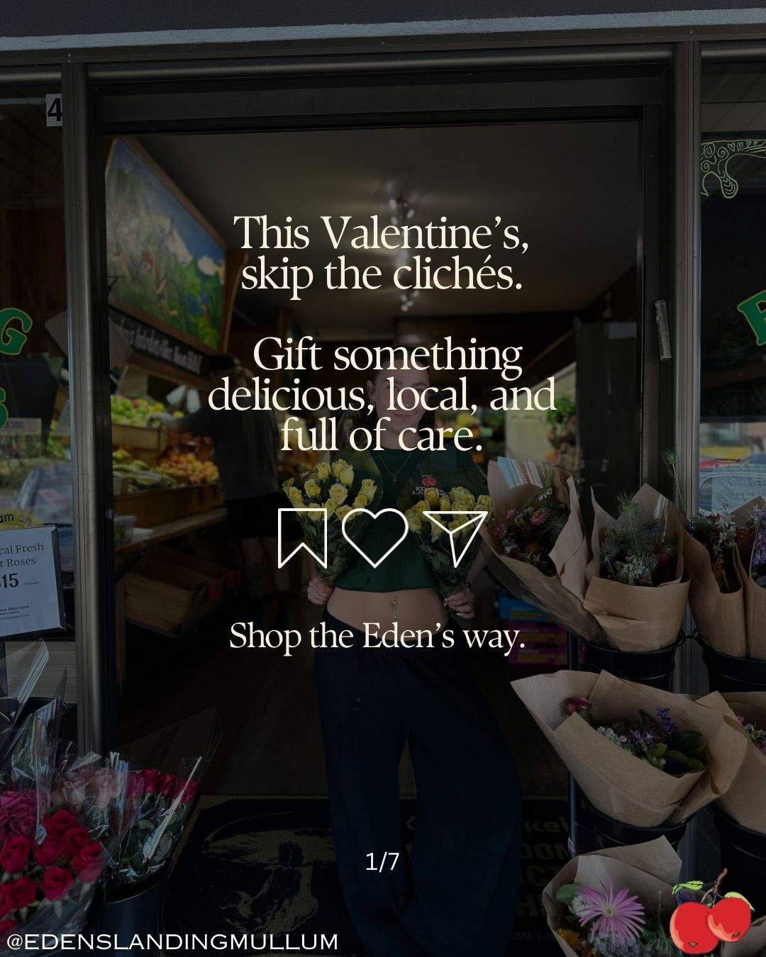 A storefront display with a Valentine's Day message and bouquets. Text says, 