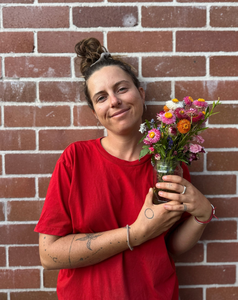 Eden’s Landing team member  Grace Holding  fresh organic flowers in Mullumbimby store