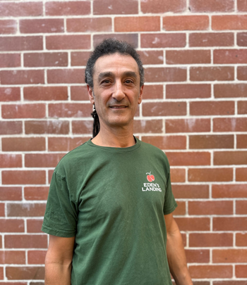 Amir Owner of Edens Landing smiling representing a local Mullumbimby organic grocery