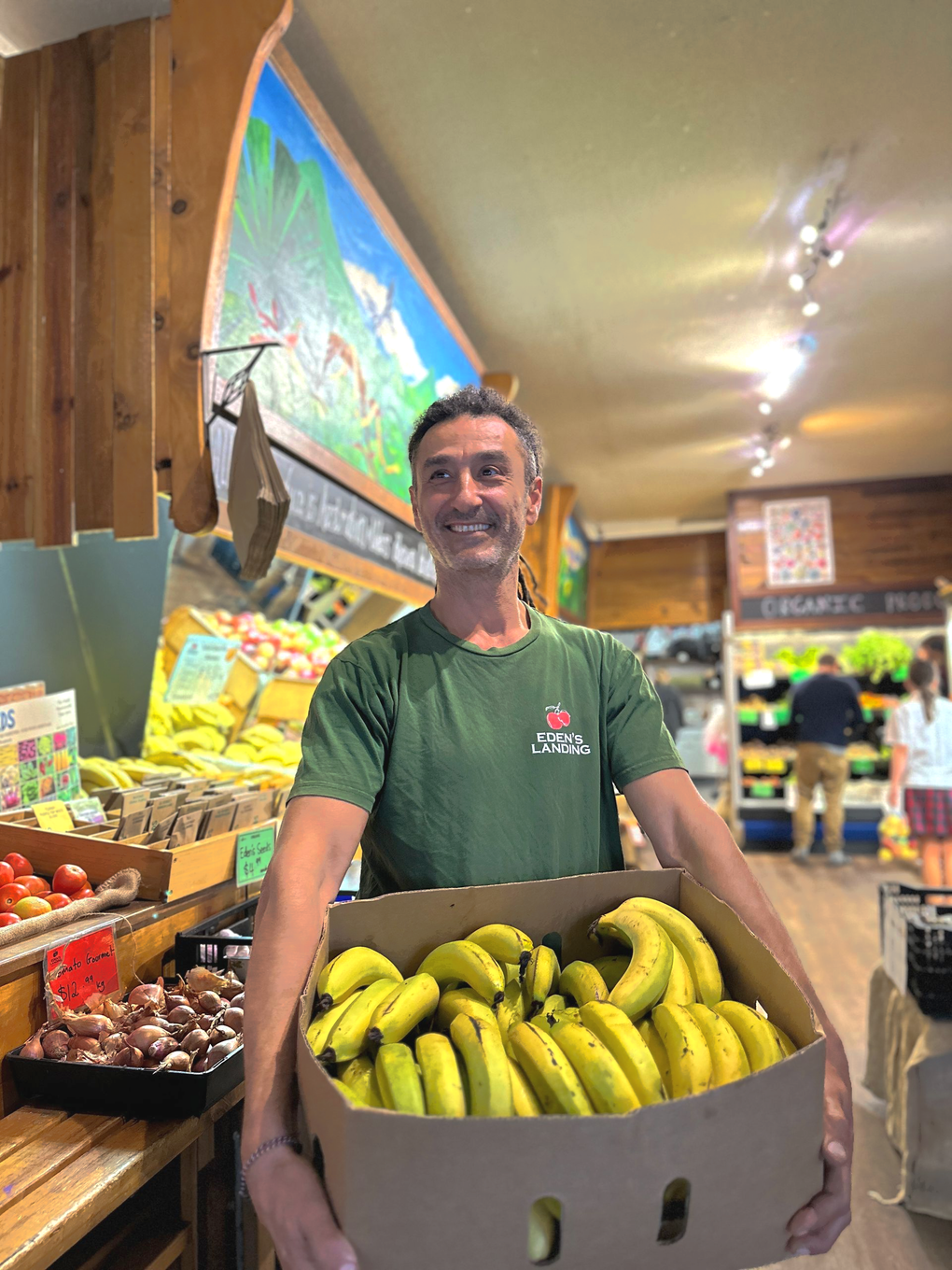 Amir Zikhron holding a box of local organic bananas at Eden’s Landing in Mullumbimby