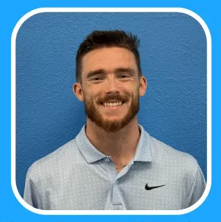 Man smiling, wearing a light blue polo shirt, against a blue background.