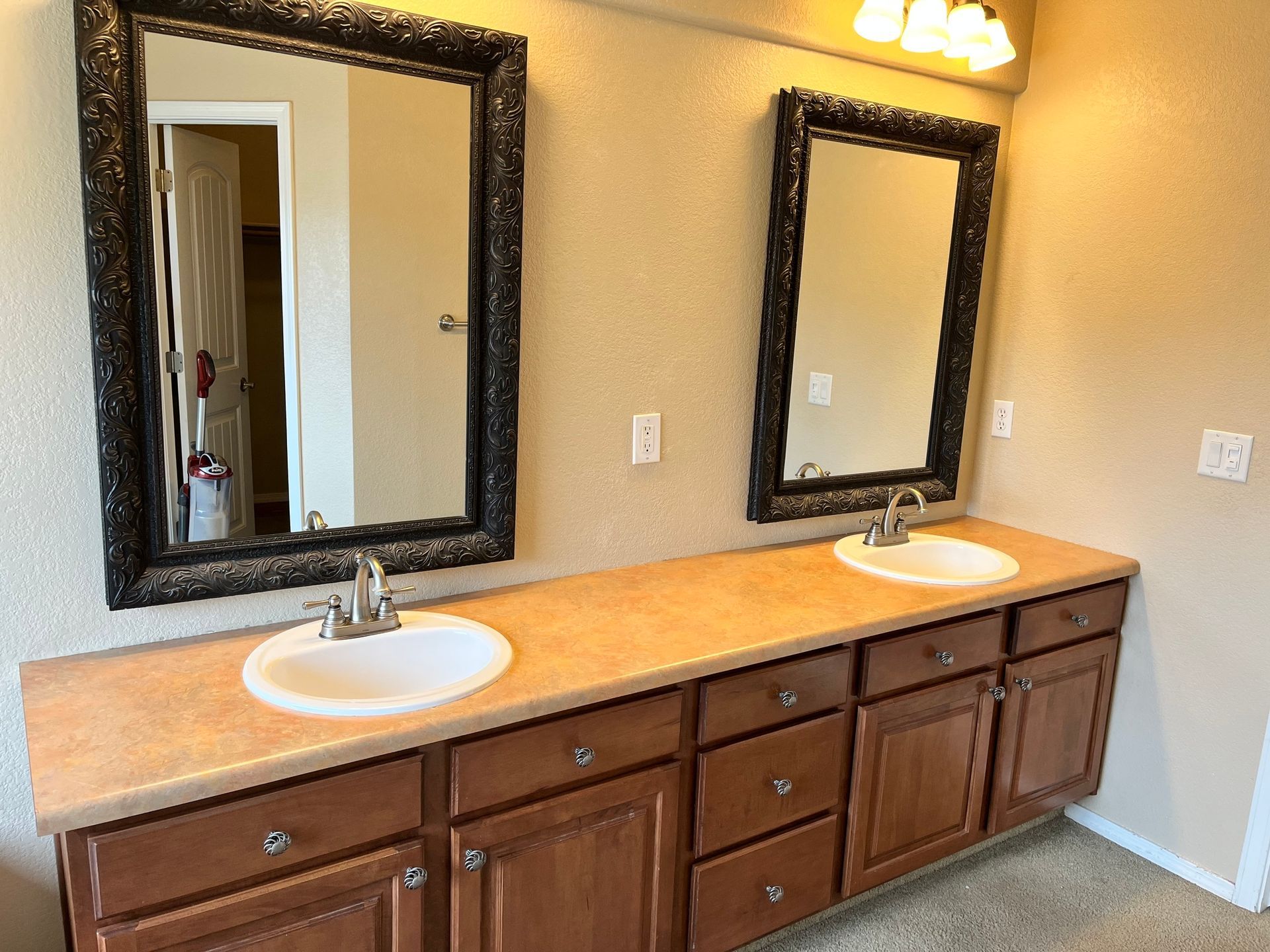 A bathroom with two sinks and two mirrors.