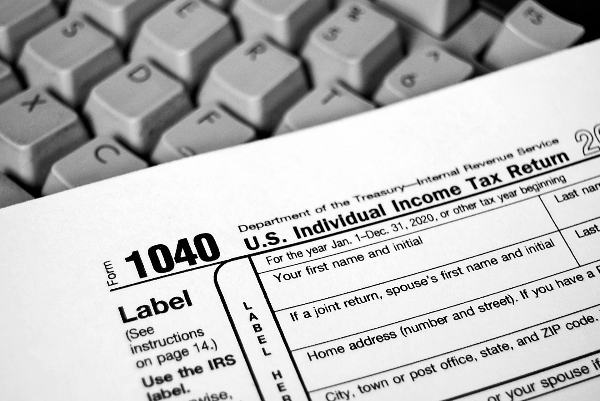 1040 tax return lying on a keyboard