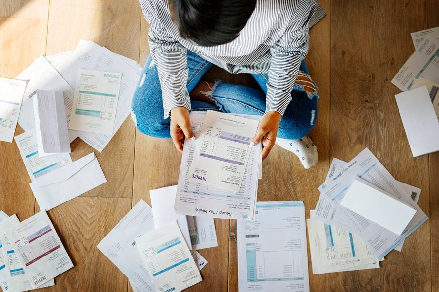 Woman Checking Bills – Compromise in Houston, TX