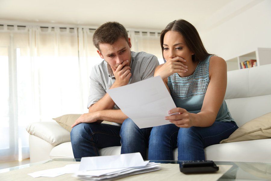 Couple Reading Bills — Houston, TX — IRS Tax Fighters