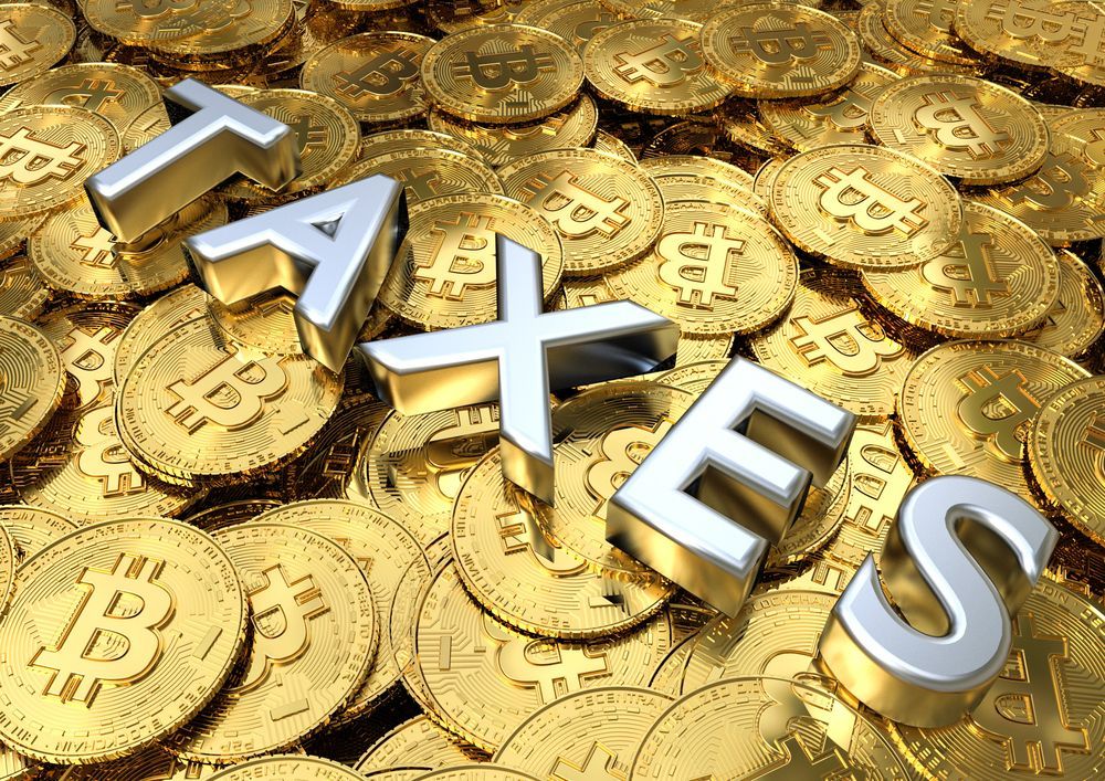 Lots of Bitcoins with the word TAXES lying on the bitcoins