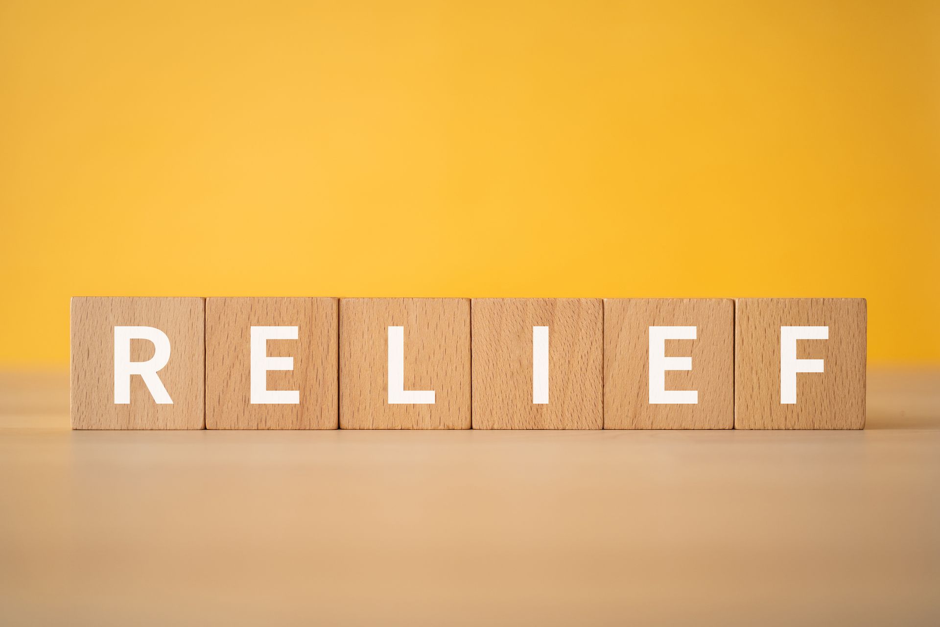 RELIEF spelled out with Scrabble pieces