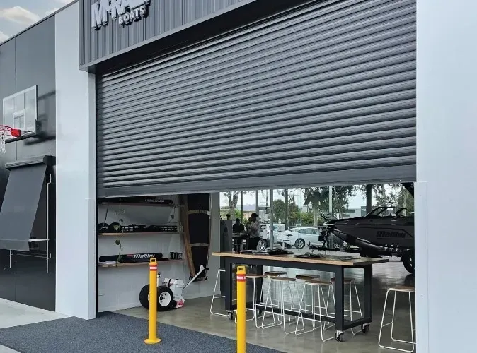 A building with a garage door open and a table in front of it — LT Shutters in Dapto, NSW