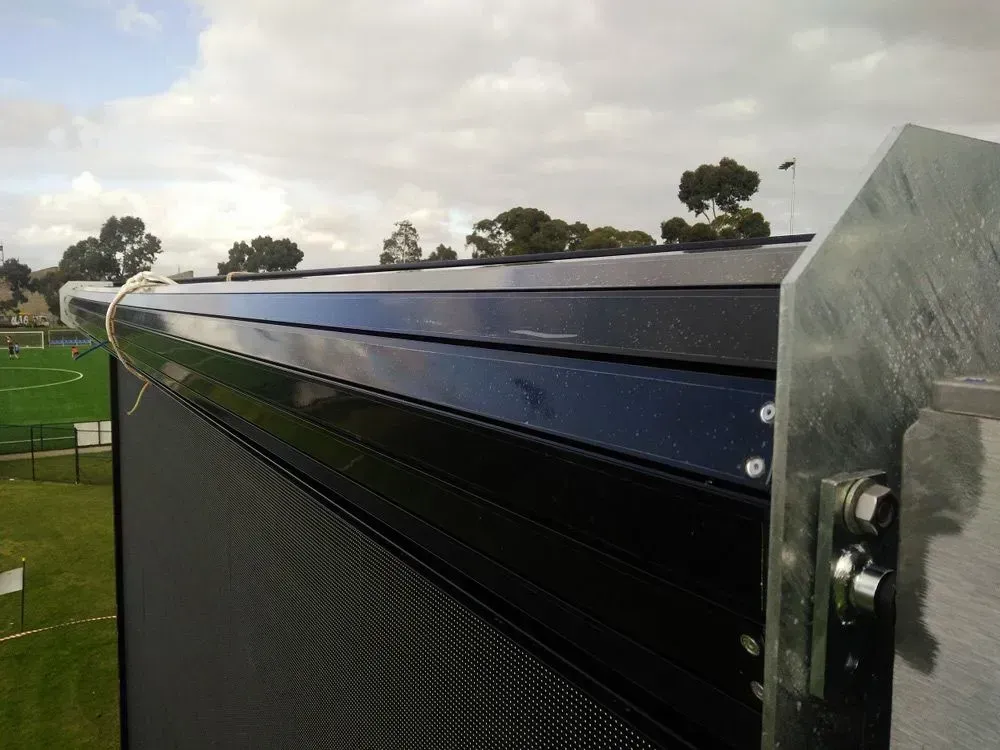A black fence with a soccer field in the background — LT Shutters in Port Kembla, NSW