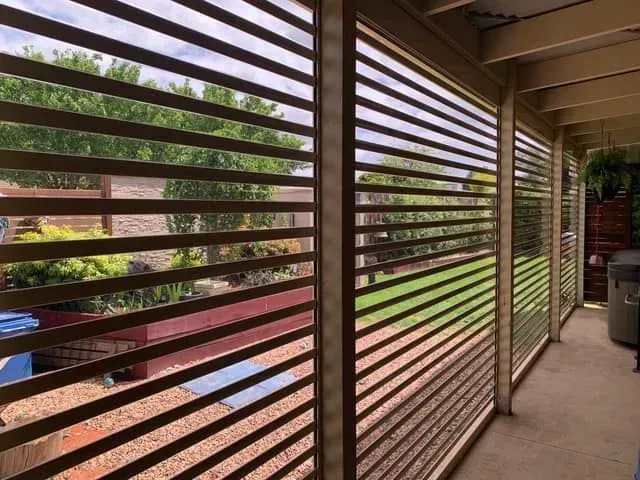 A patio with a row of shutters on the side of it — LT Shutters in Moss Vale, NSW