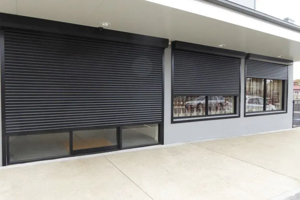 A building with a lot of windows and shutters on it — LT Shutters in Bowral, NSW