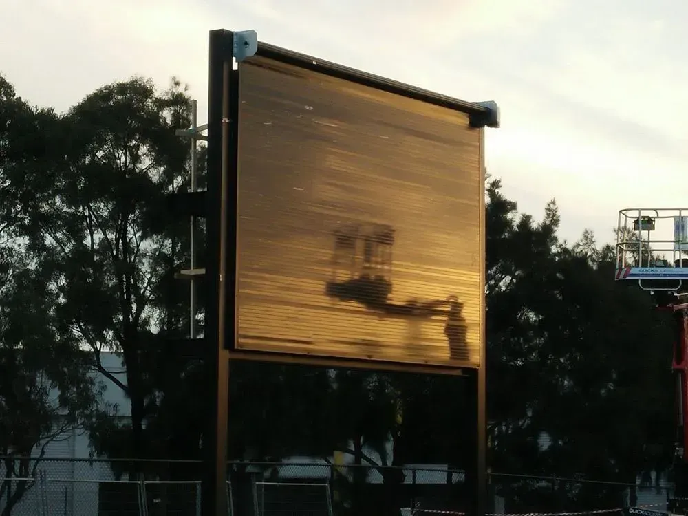 A large billboard with trees in the background — LT Shutters in Albion Park, NSW