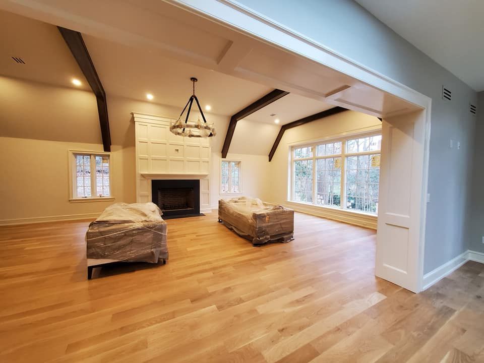 A living room with hardwood floors and a fireplace.