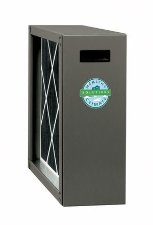 Dirty HVAC filter in front of an open cabinet with visible wires and components
