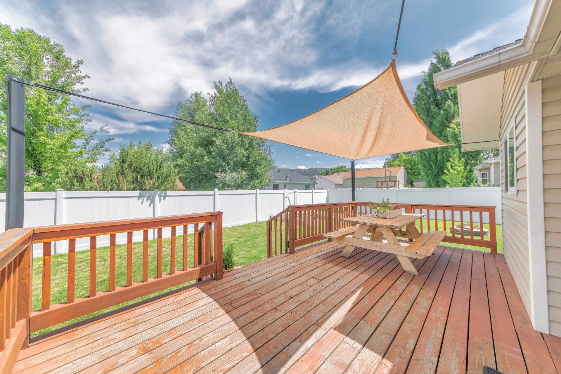 Awning covering backyard patio and picnic table