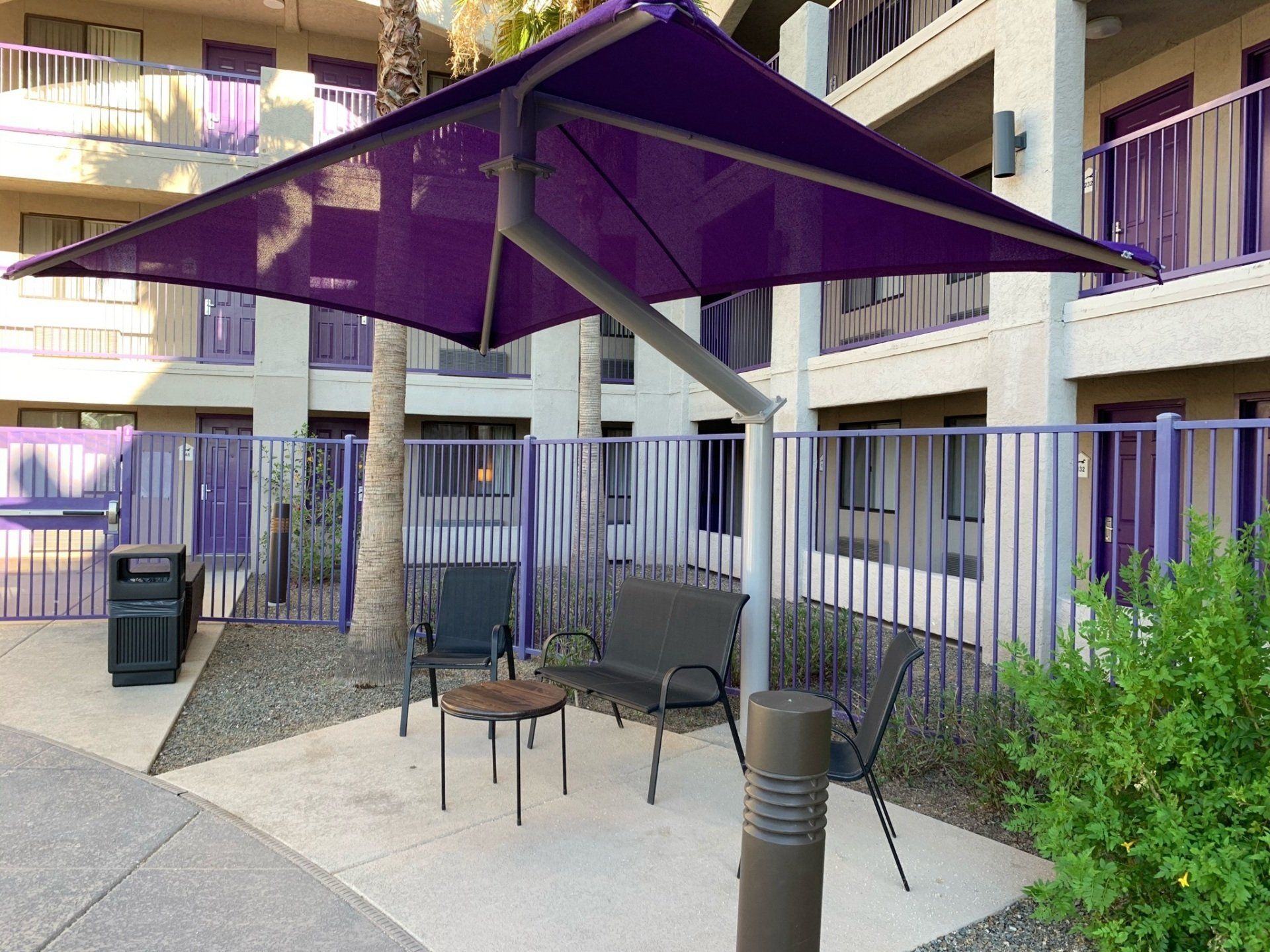 purple awning built over a table and chairs in an apartment complex in Arizona by Arizona Awnings