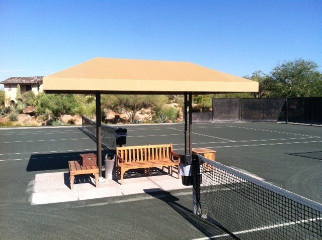 wooden benches at tennis court covered by AZ Awning