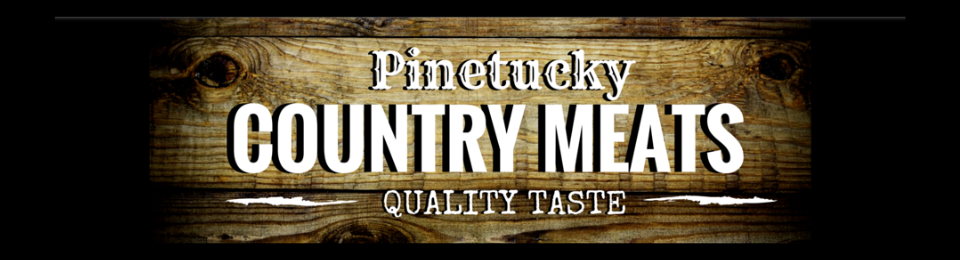 Logo for Pinetucky Country Meats featuring bold white text on a dark wooden background.