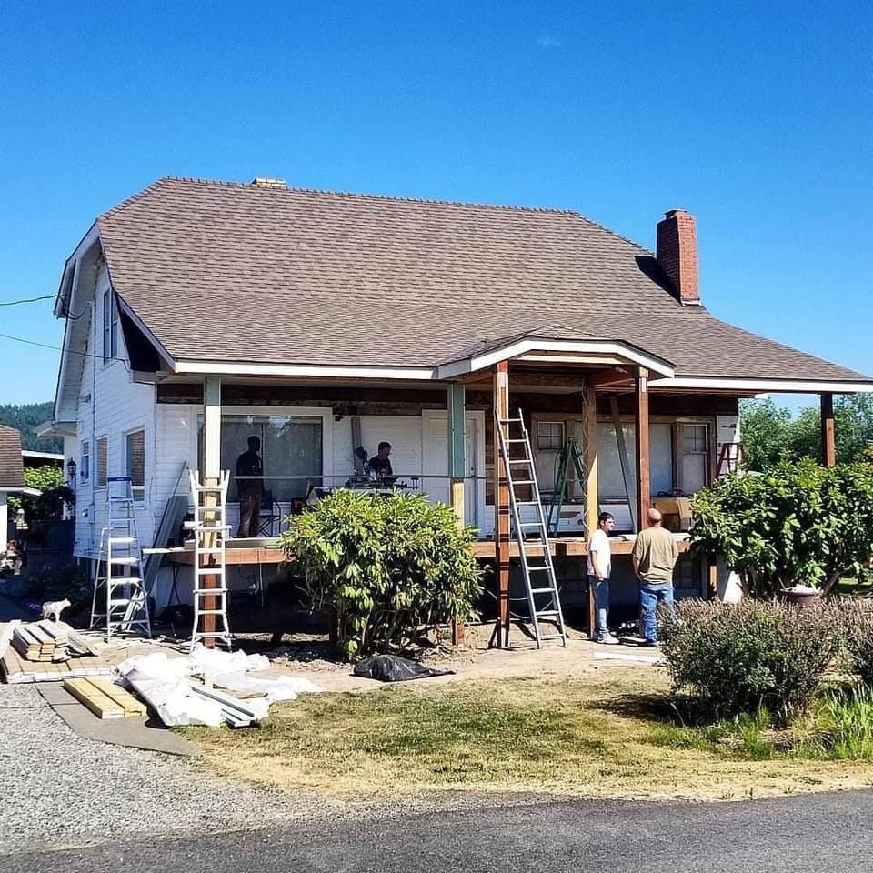 A man wearing a hard hat and goggles is standing in a room.