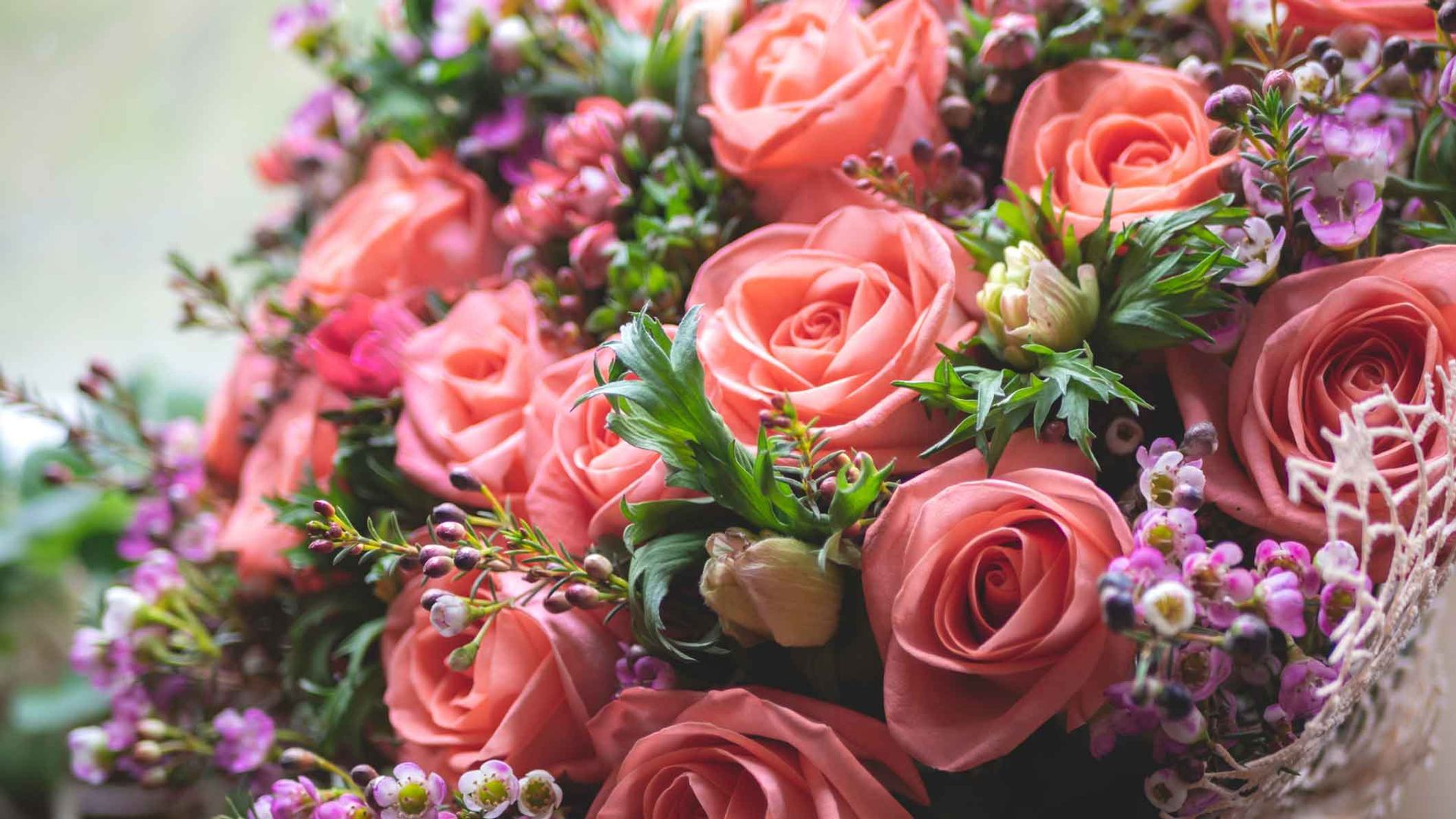 Bouquet of pink roses, purple flowers, and greenery arranged in soft pastel tones Bouquet of pink roses, purple flowers, and greenery arranged in soft pastel tones