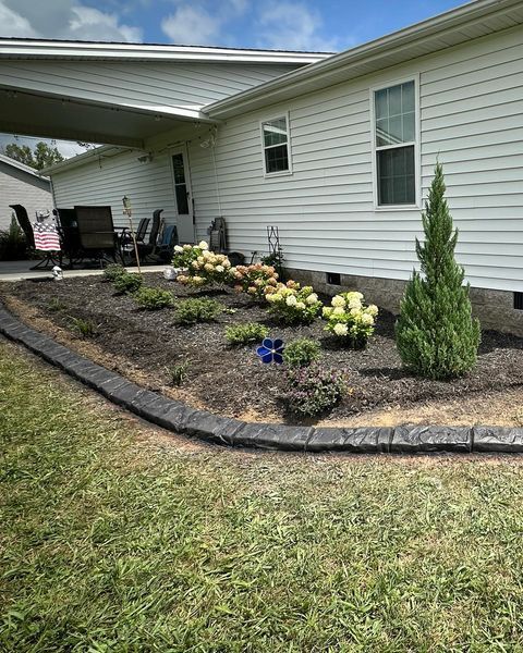 A mobile home with a garden in front of it.