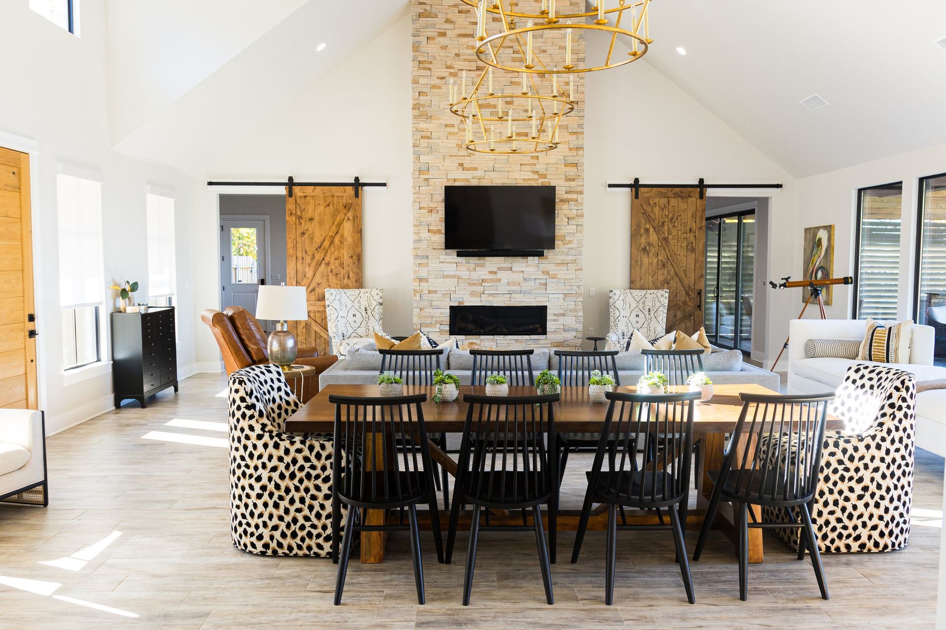 A living room with a dining table , chairs , and a television.