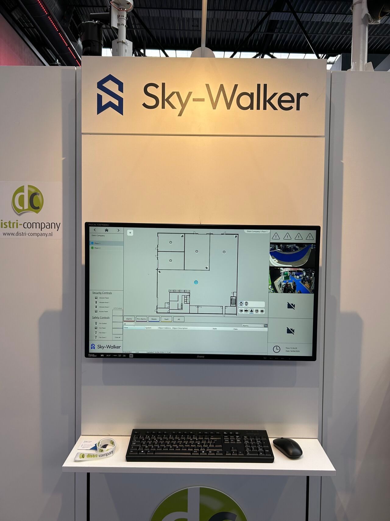 Sky-Walker booth with a wall-mounted monitor showing a floor plan and a laptop on a white desk.