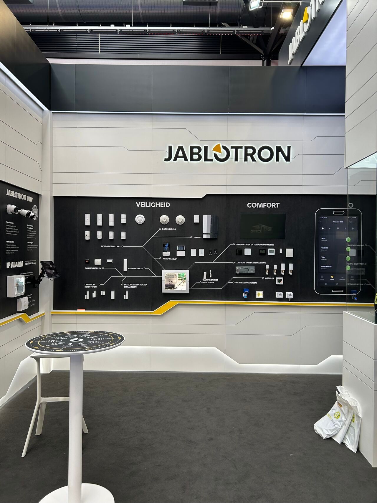 JABLOTRON exhibition booth with black wall displays and product panels in a trade show setting