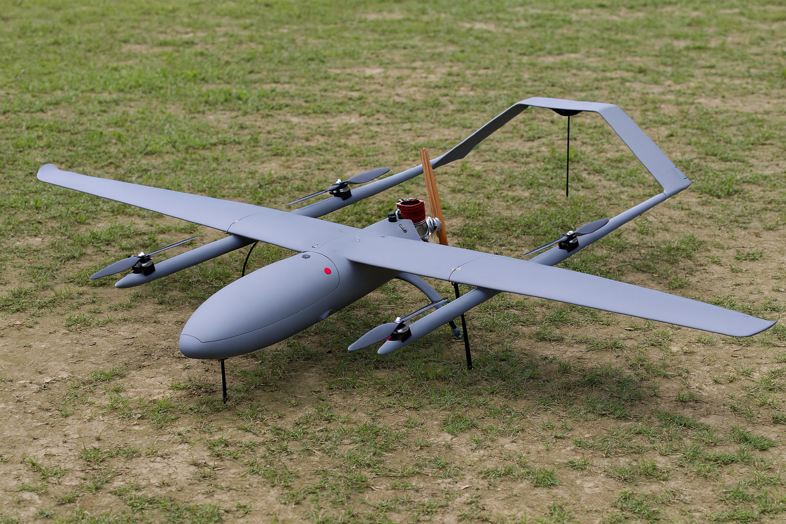 White eVTOL aircraft on a dry, cracked lakebed, with a mountain range in the background at sunset. Connected to the Sky-Walker network.