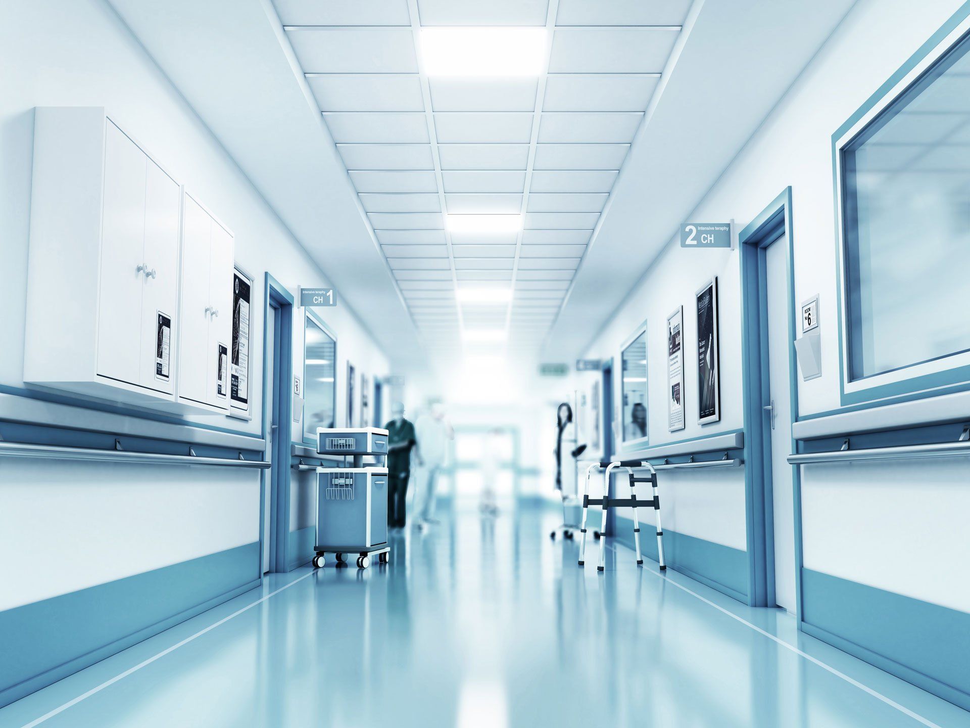 A healthcare facility corridor with crash cart and nurses