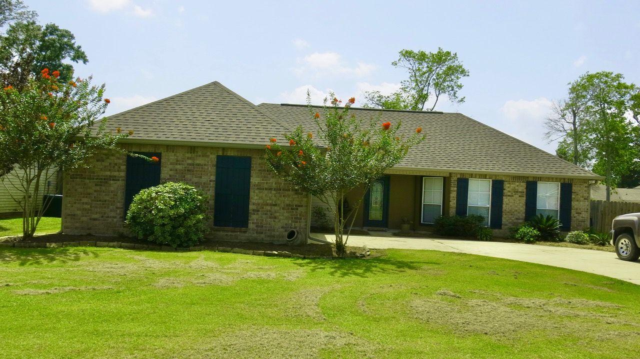 A brick house with a truck parked in front of it